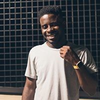 Portrait of Isaac Efik smiling, wearing a light T-shirt